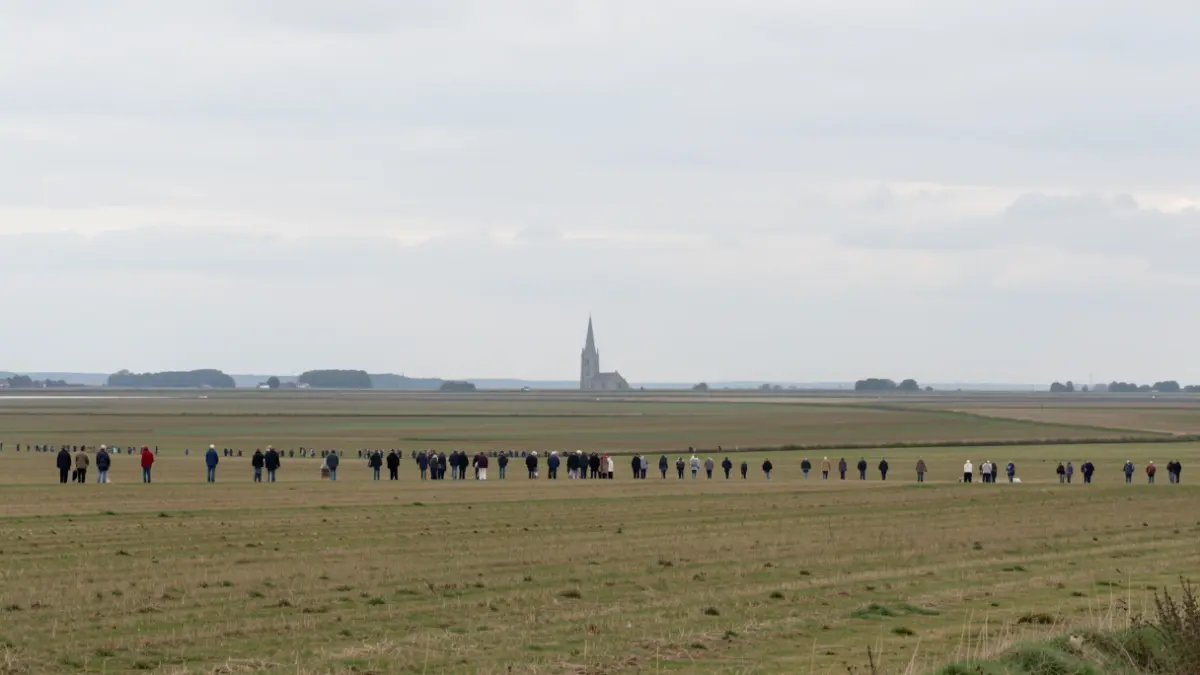 Generic image of a wide, open sky over the flat landscape of the East of England Fens, with a single, distant flint church spire visible on the horizon.